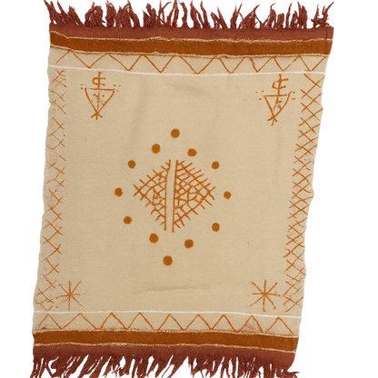 Beige Berber rug with rust-brown geometric patterns, central diamond, dots, and fringed edges